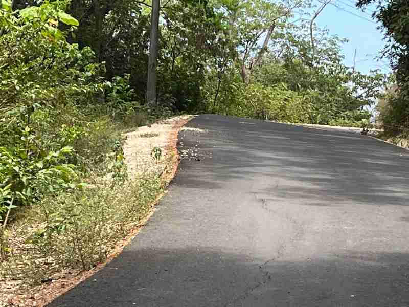 Completed paved road at Nosara Estates community showing finished 1.6 mile road